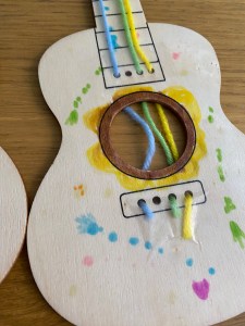 My son's decoration up close, and also showing how the yarn was taped in place to secure the strings.