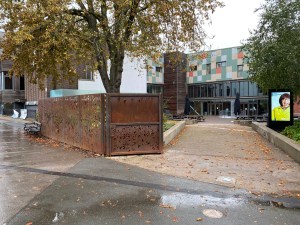 The park entrance to MAC. You can see the decorative metal fencing around the courtyard area and the colourful exterior to the building.