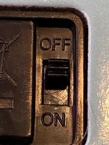 The on/off switch on the back of the book.