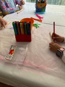 Decorating the wooden part with felt pens.