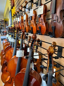 A display of violins and cellos available to purchase on the day of my visit, focussing mainly on the violins.