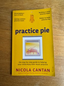 The bright yellow front cover of the book Practice Pie by Nicola Cantan. As well as the title and author name, there are bullet points with reasons for reading the book: "Encouraging a love of music"; "Building a solid practice habit"; "Solving common practice issues"; "Games to make practice fun" "the step-by-step guide to helping your child enjoy their music practice". There is also an image of an over with musical instruments inside, and an oven glove dangles in the top centre of the book!